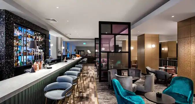 a room with a bar and chairs