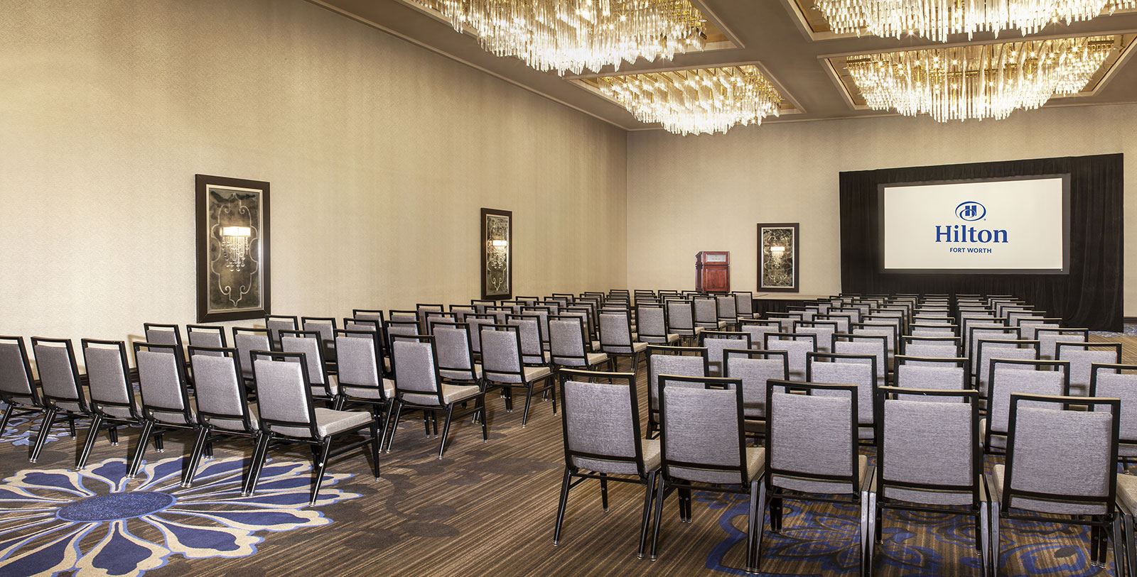 a room with chairs and chandeliers
