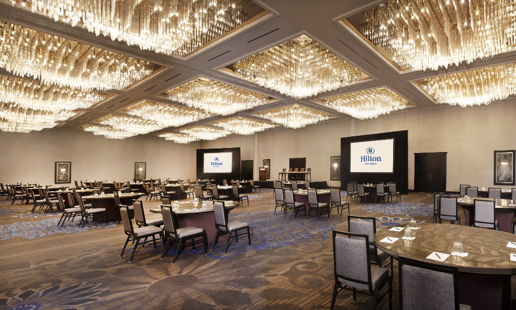 a room with chandeliers and tables
