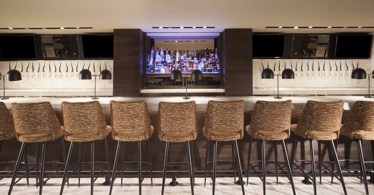 a row of chairs in a bar