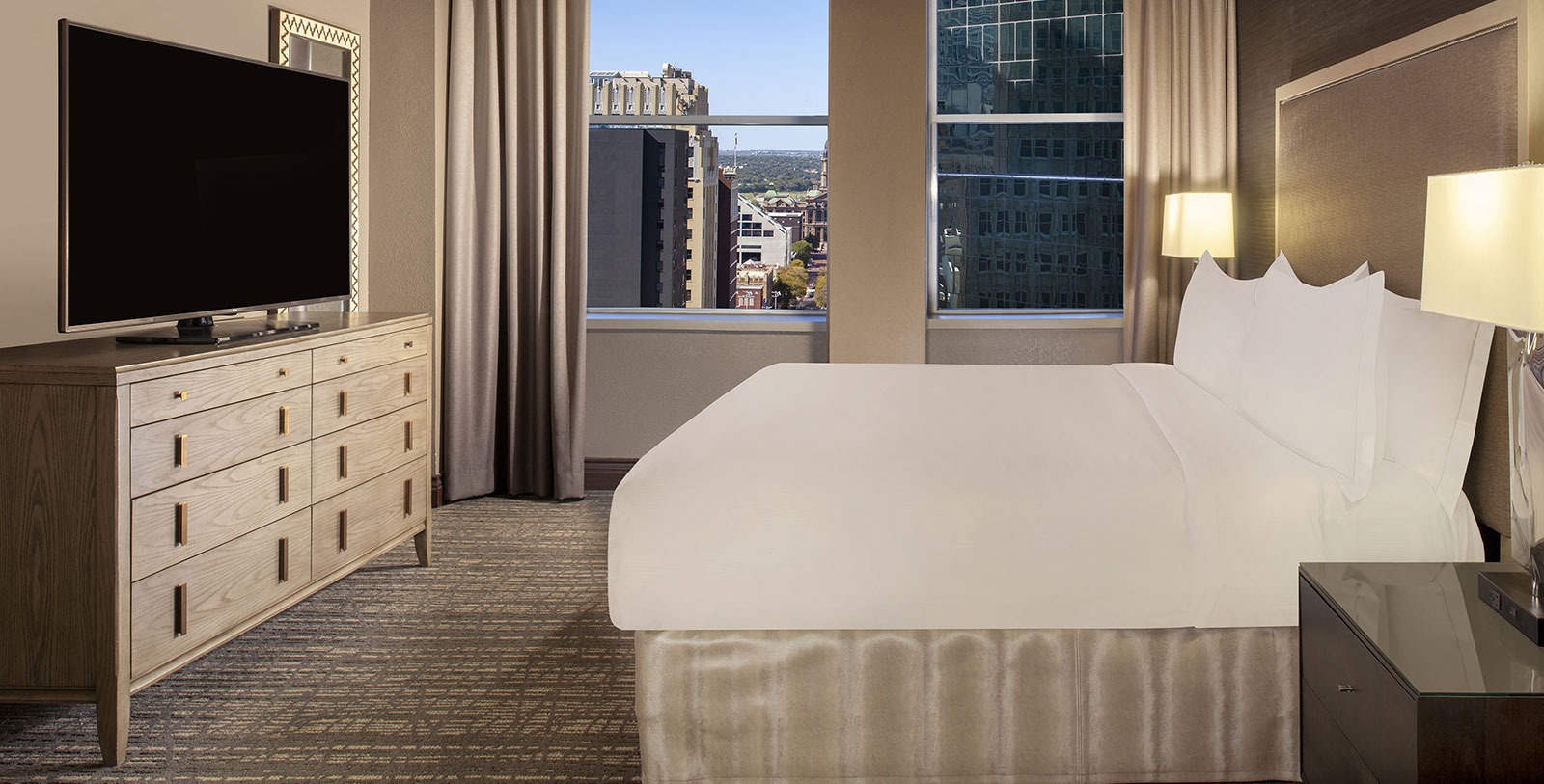 a bedroom with a large bed and a window