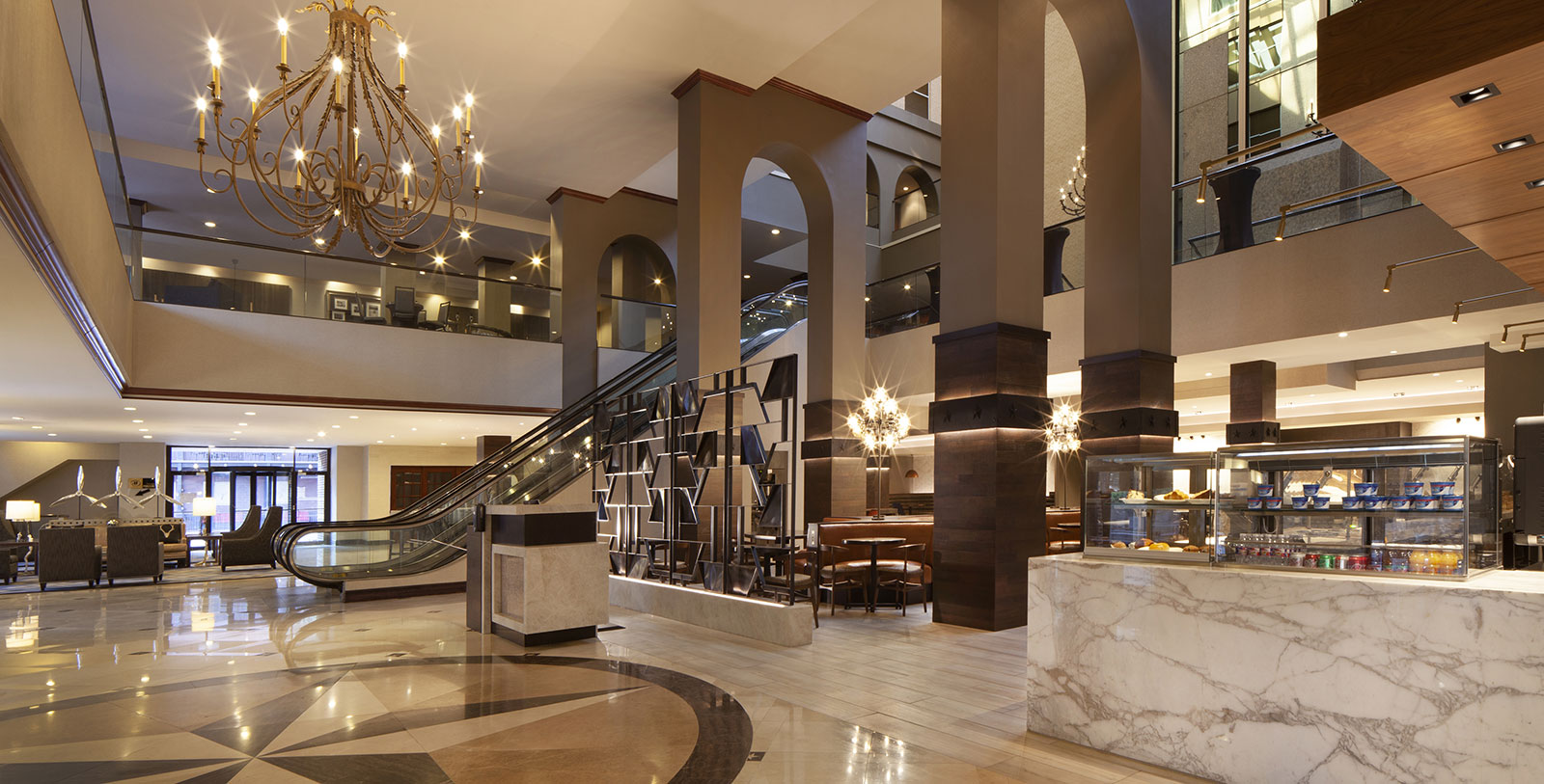a large building with an escalator and a chandelier