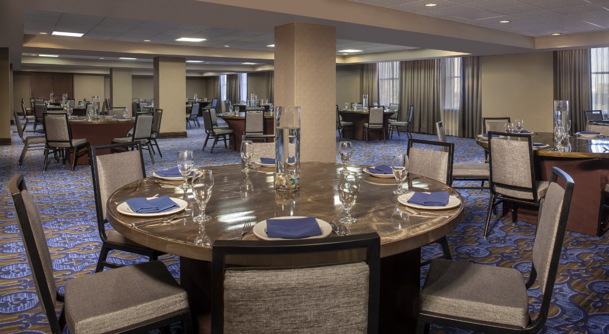 a room with a round table and chairs