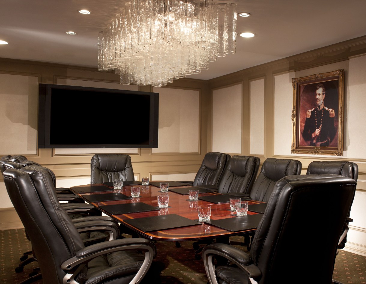 a conference room with a large chandelier and a table