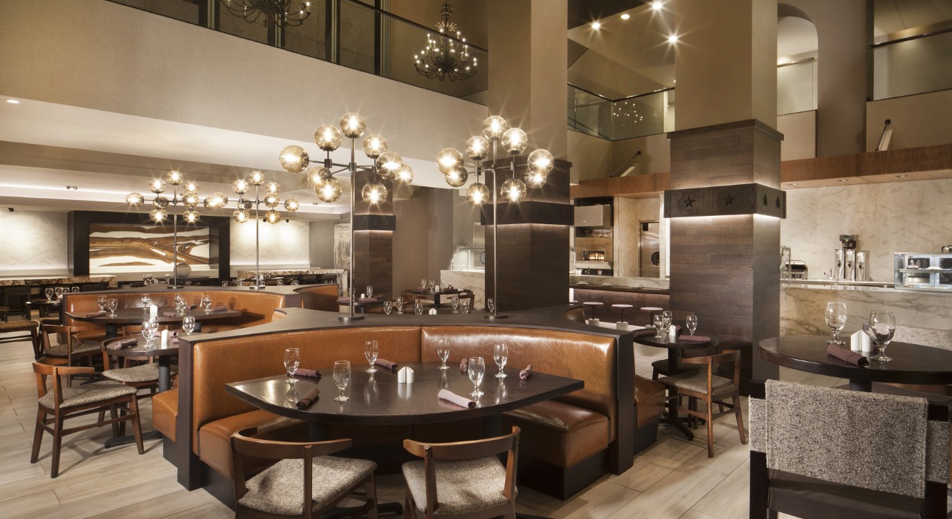 a restaurant with a chandelier and tables