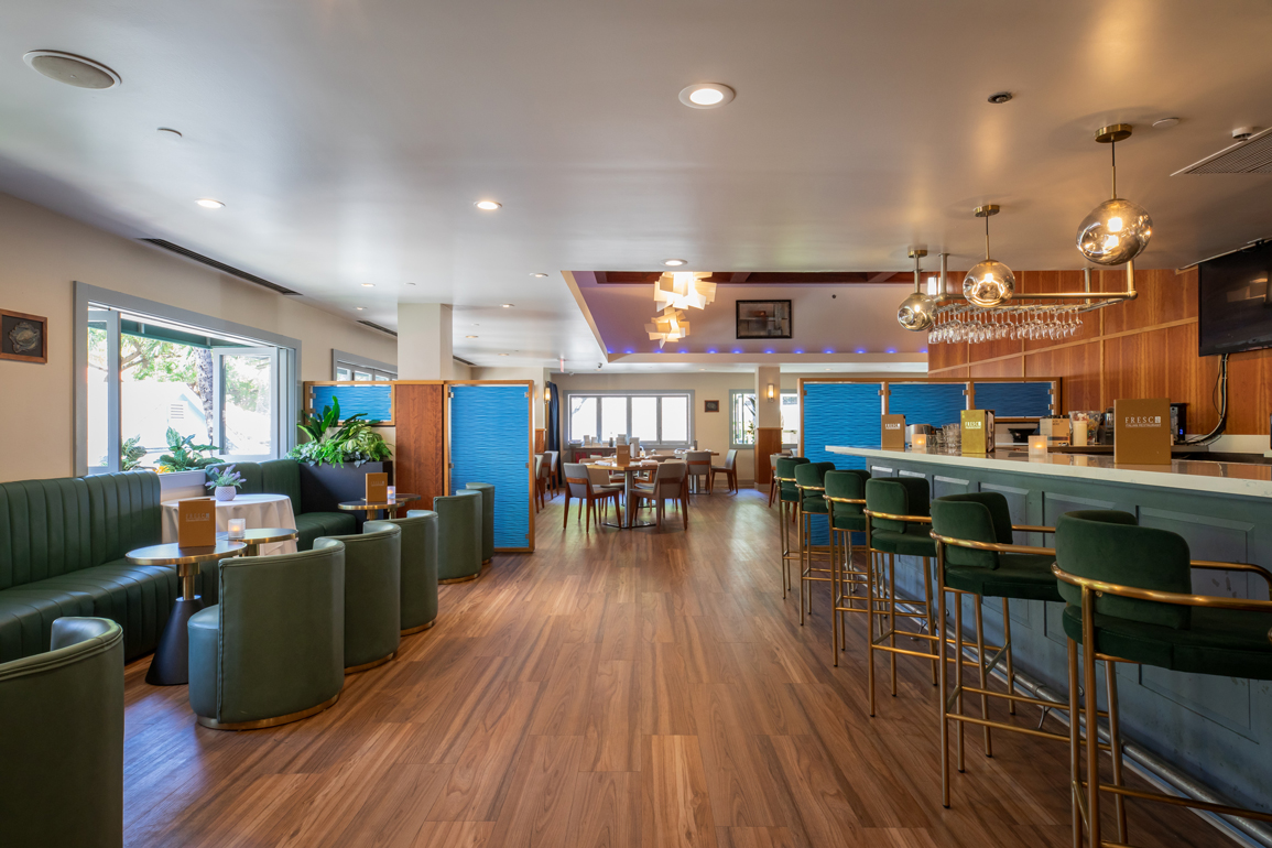 a room with a bar and tables
