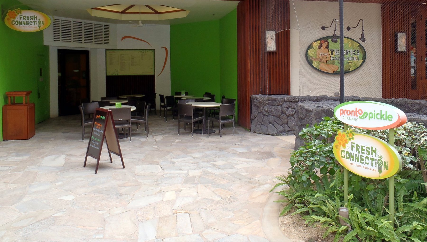 a patio with tables and chairs