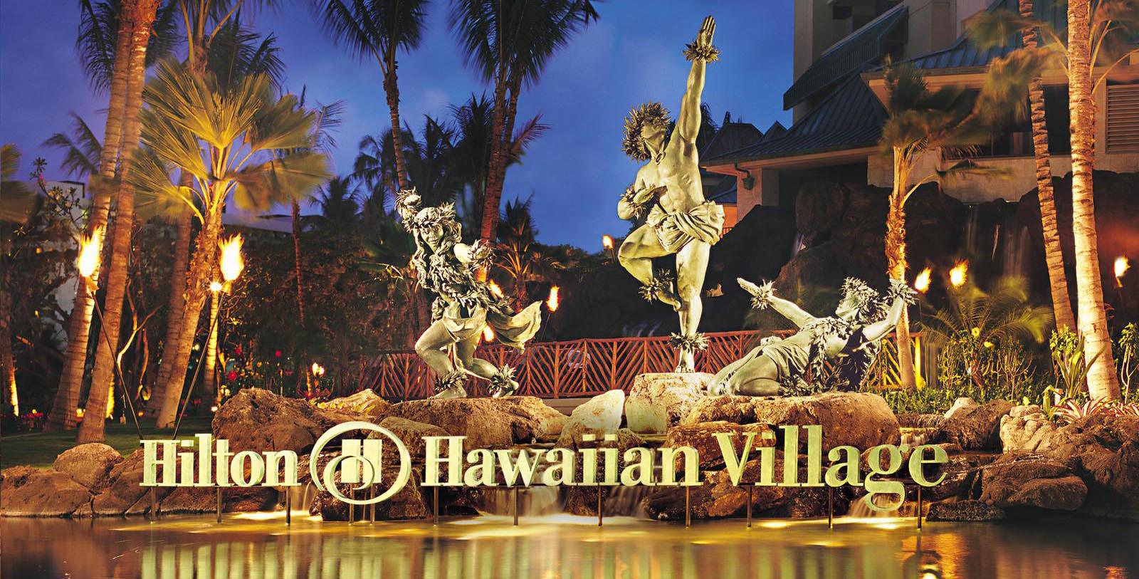 statues of hula dancers in front of a pool of water