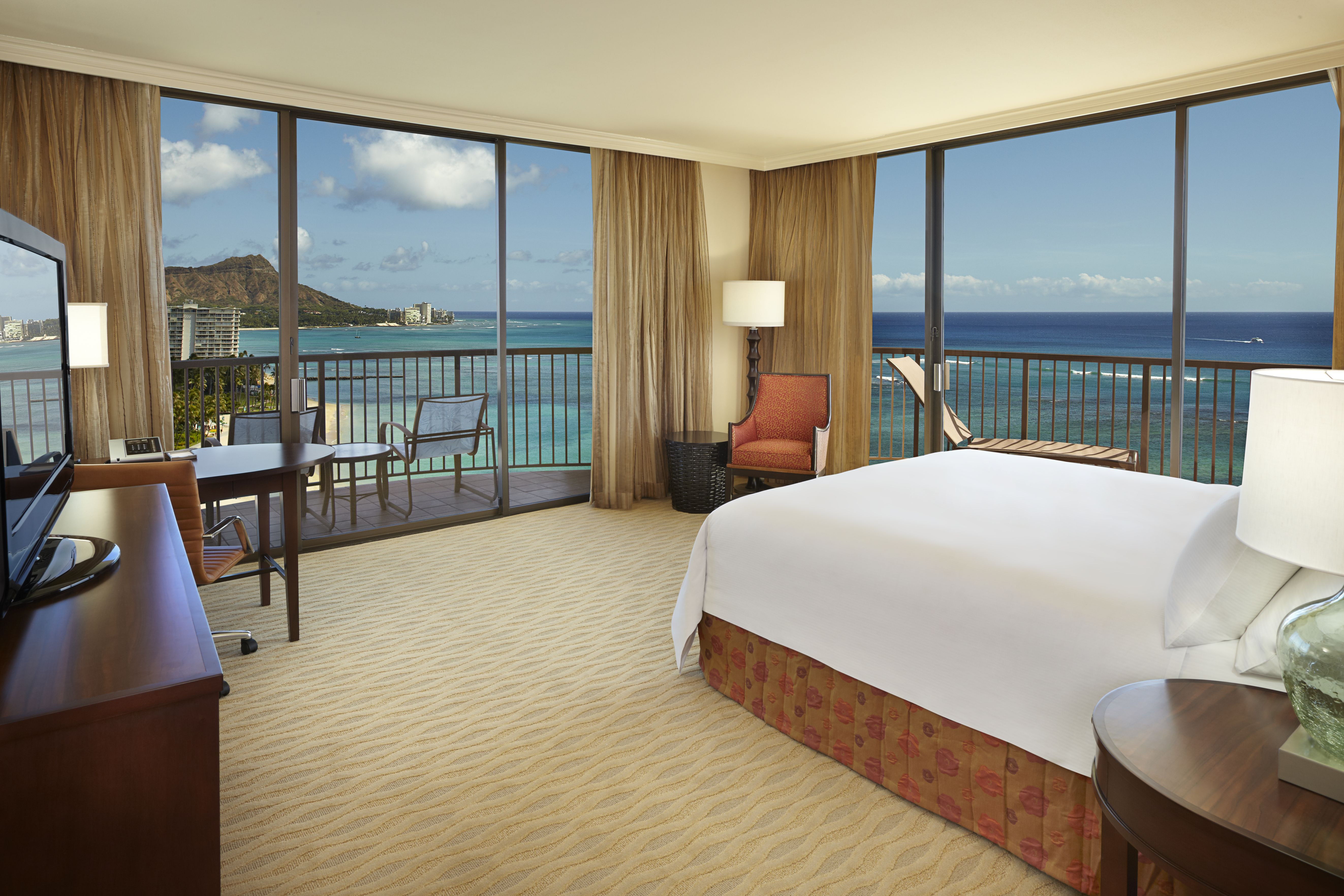 a room with a view of the ocean and a beach