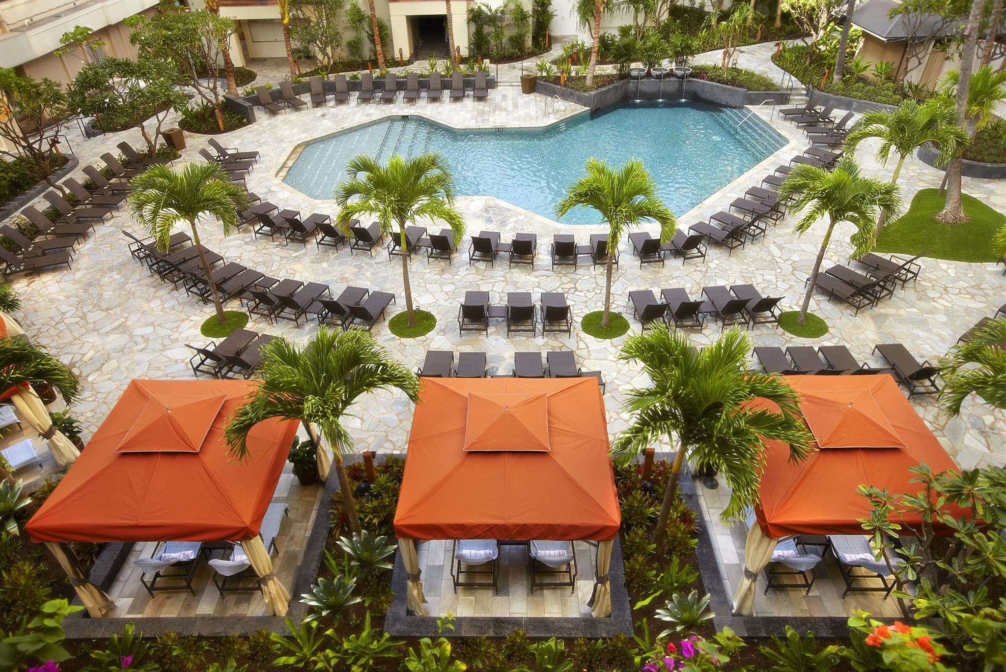 a pool with lounge chairs and umbrellas