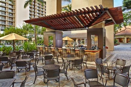 a patio area with tables and chairs