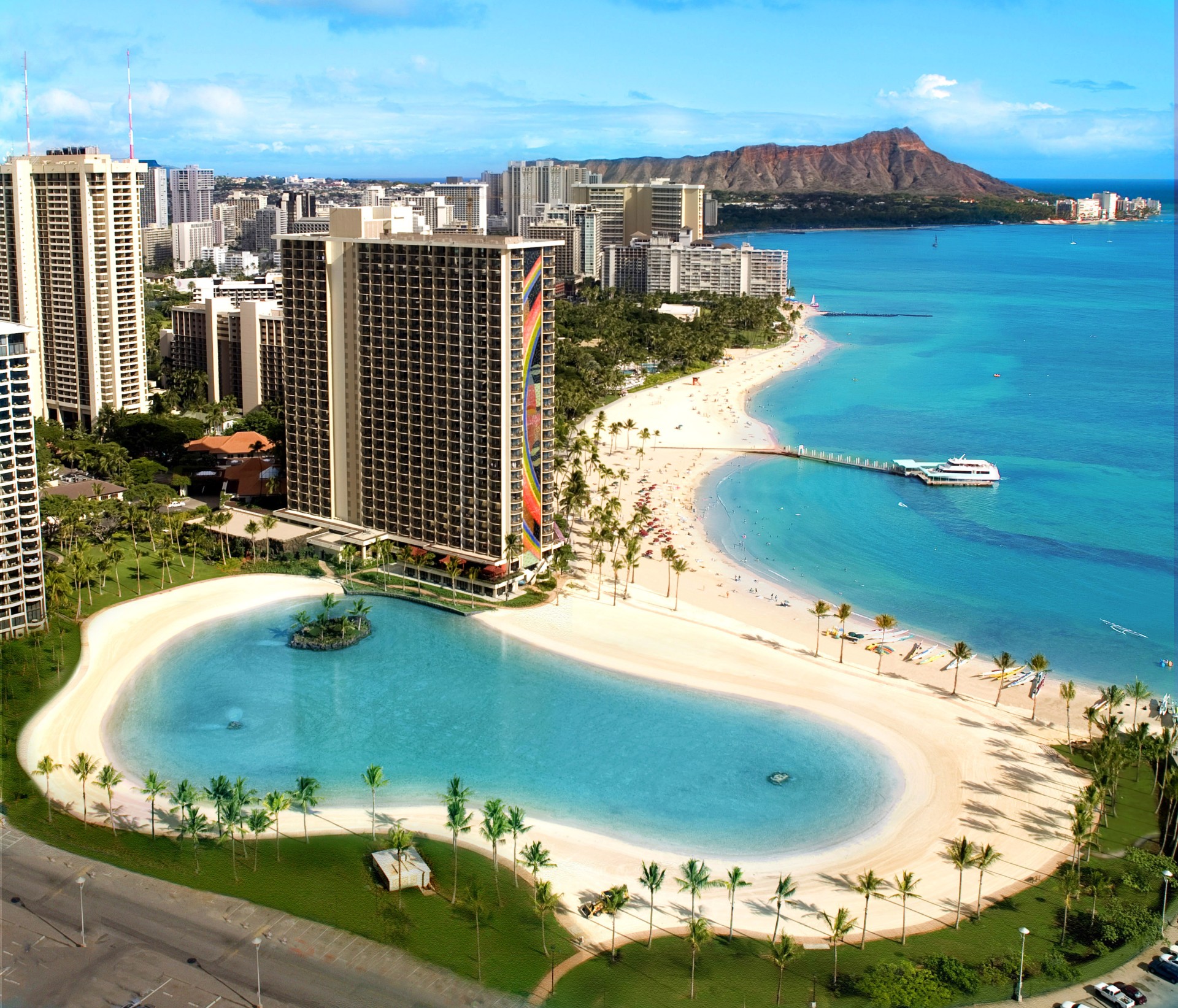 a beach with a body of water and buildings