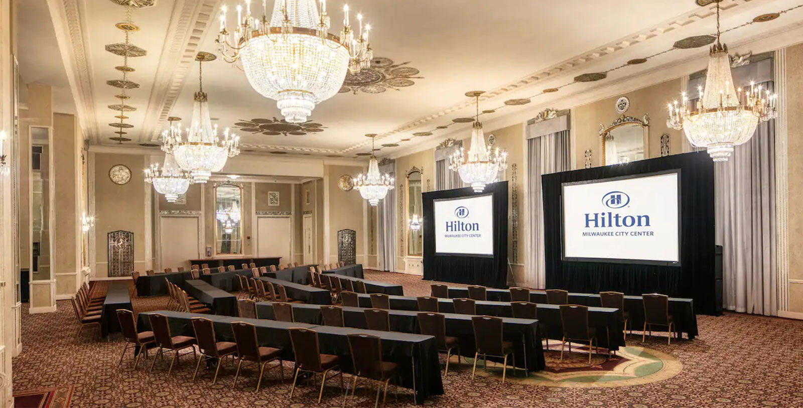 a room with chairs and a screen