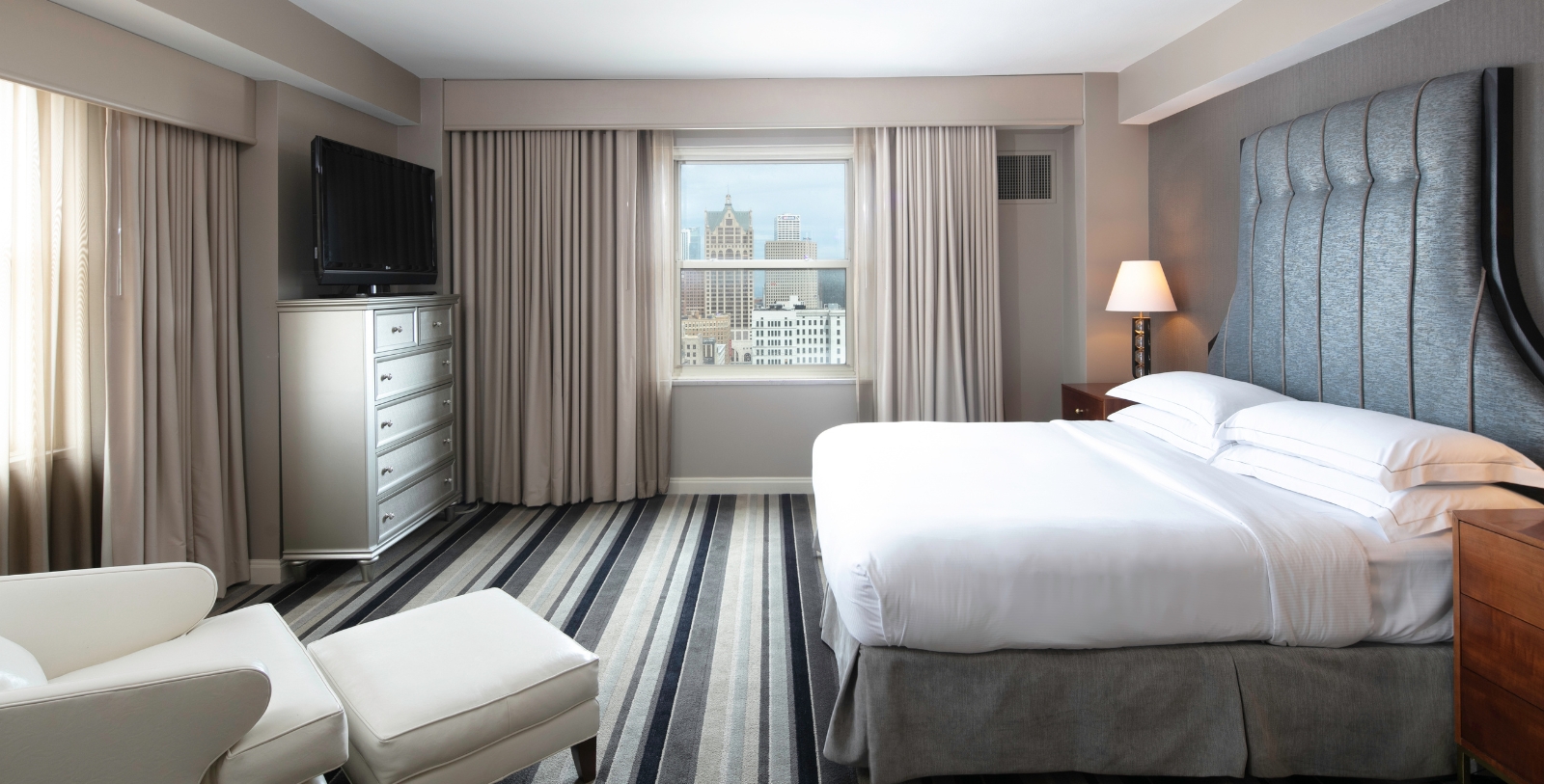 a bedroom with a bed and a television