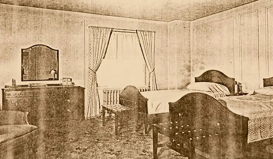 a bedroom with a bed and chairs