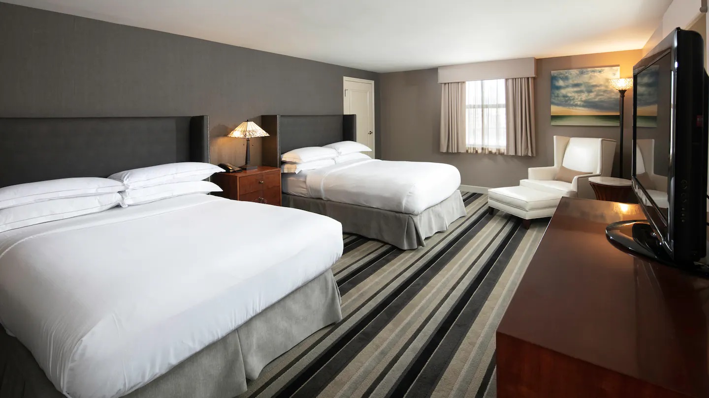 a room with two beds and a table