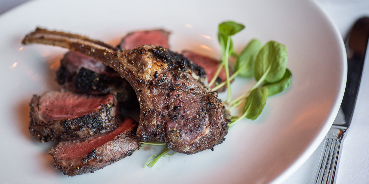 a plate of meat with herbs