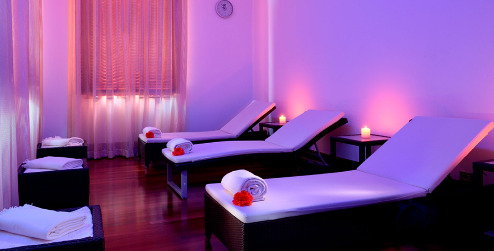 a room with chairs and candles
