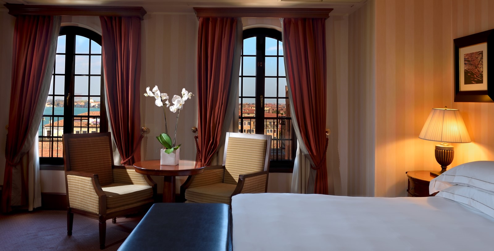 a room with a bed and chairs and a table