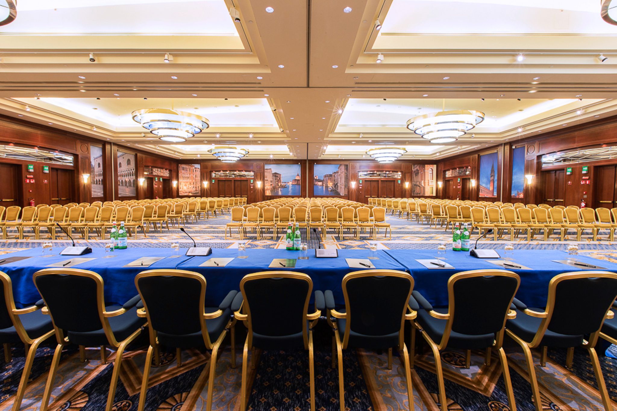 a large conference room with blue table cloth and chairs