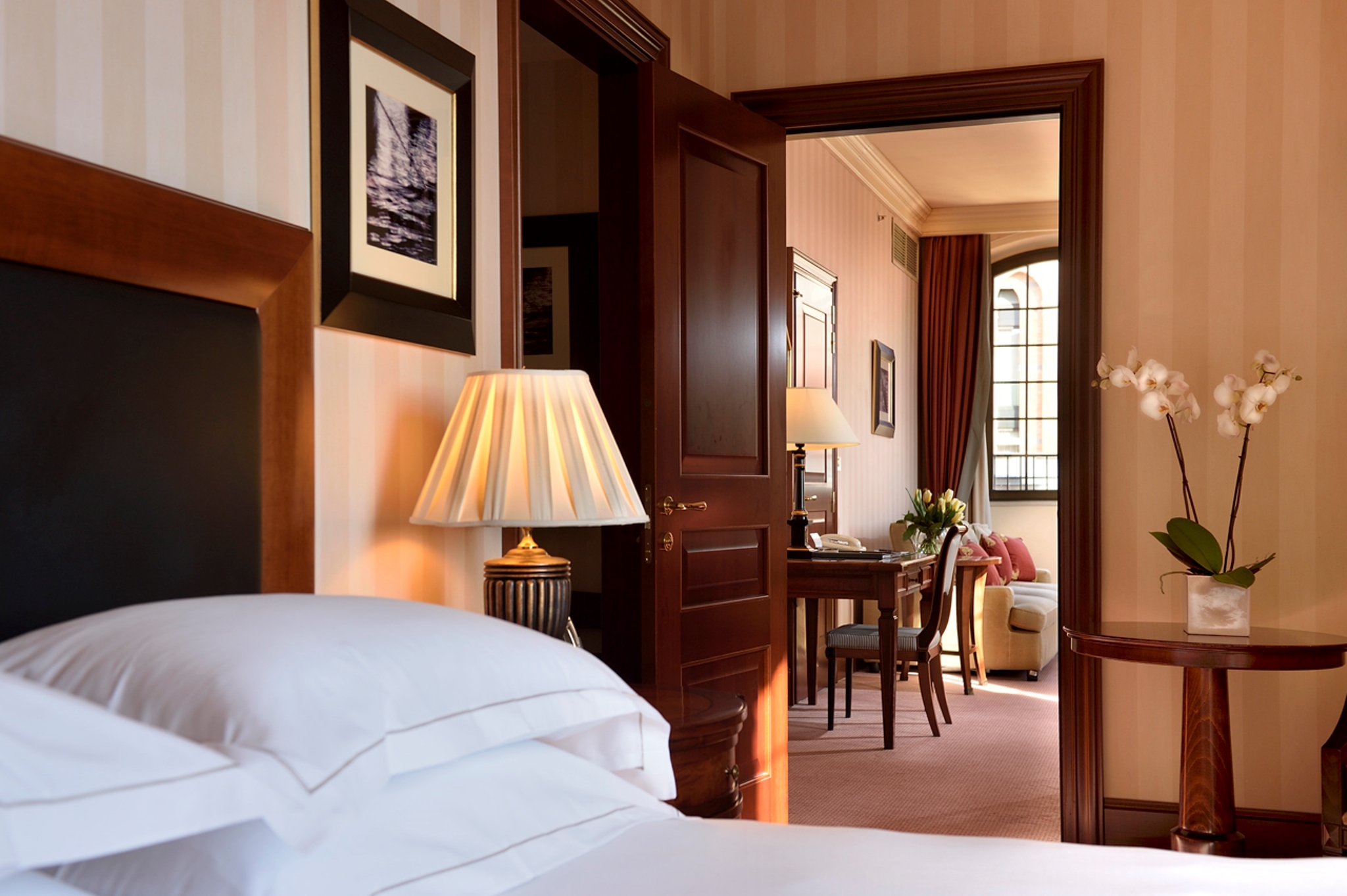 a bedroom with a lamp and a table