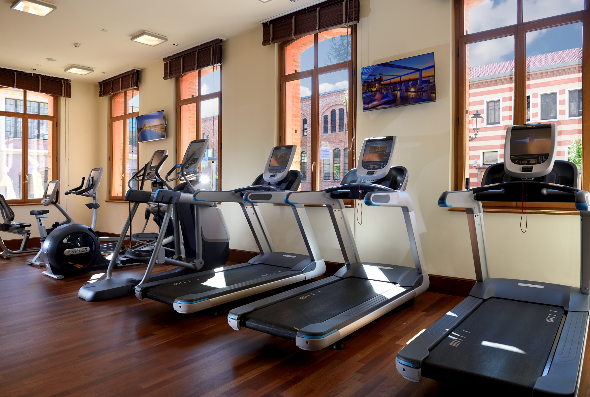 a room with treadmills and a wood floor