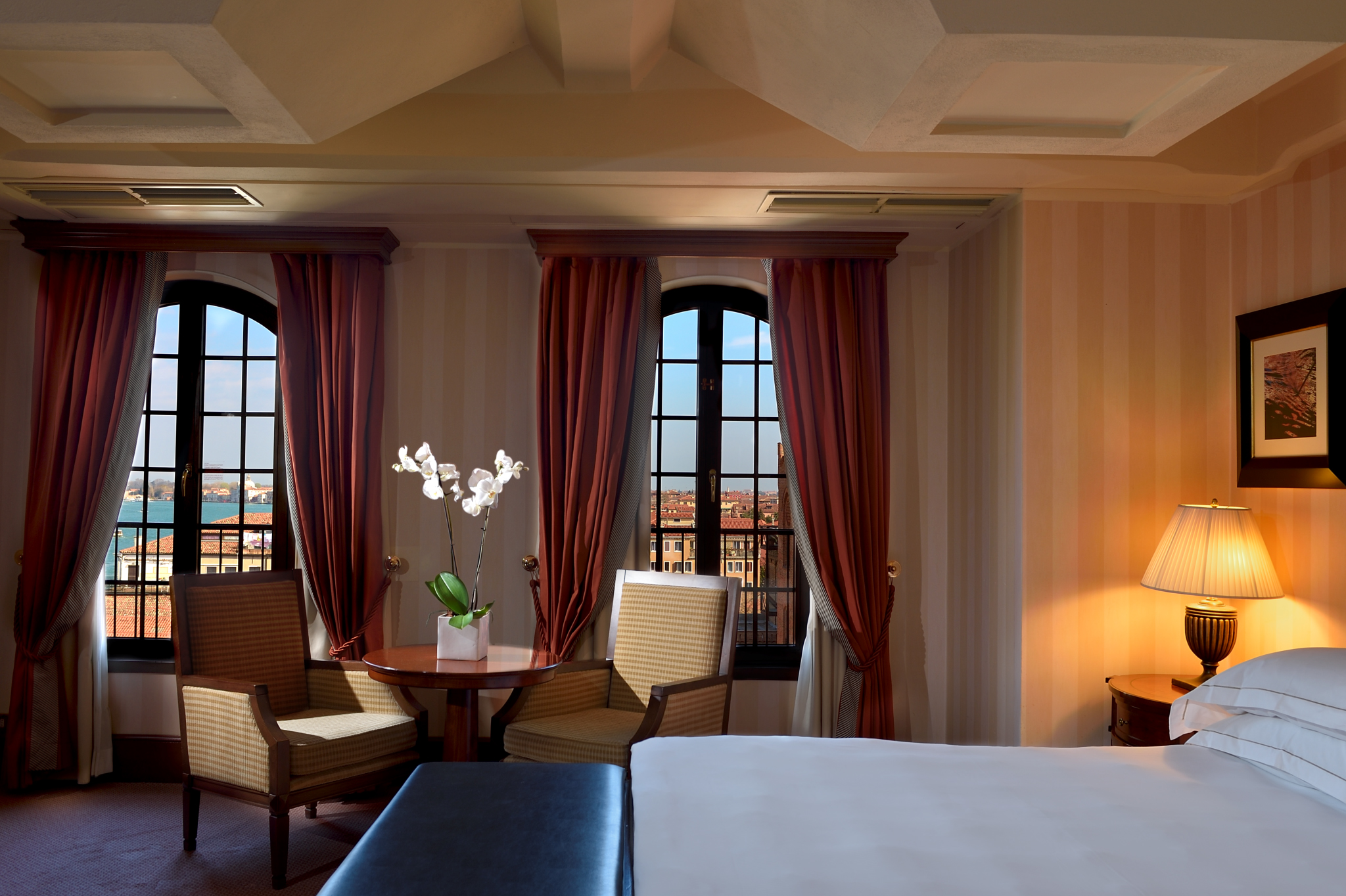 a room with a bed and chairs and a table
