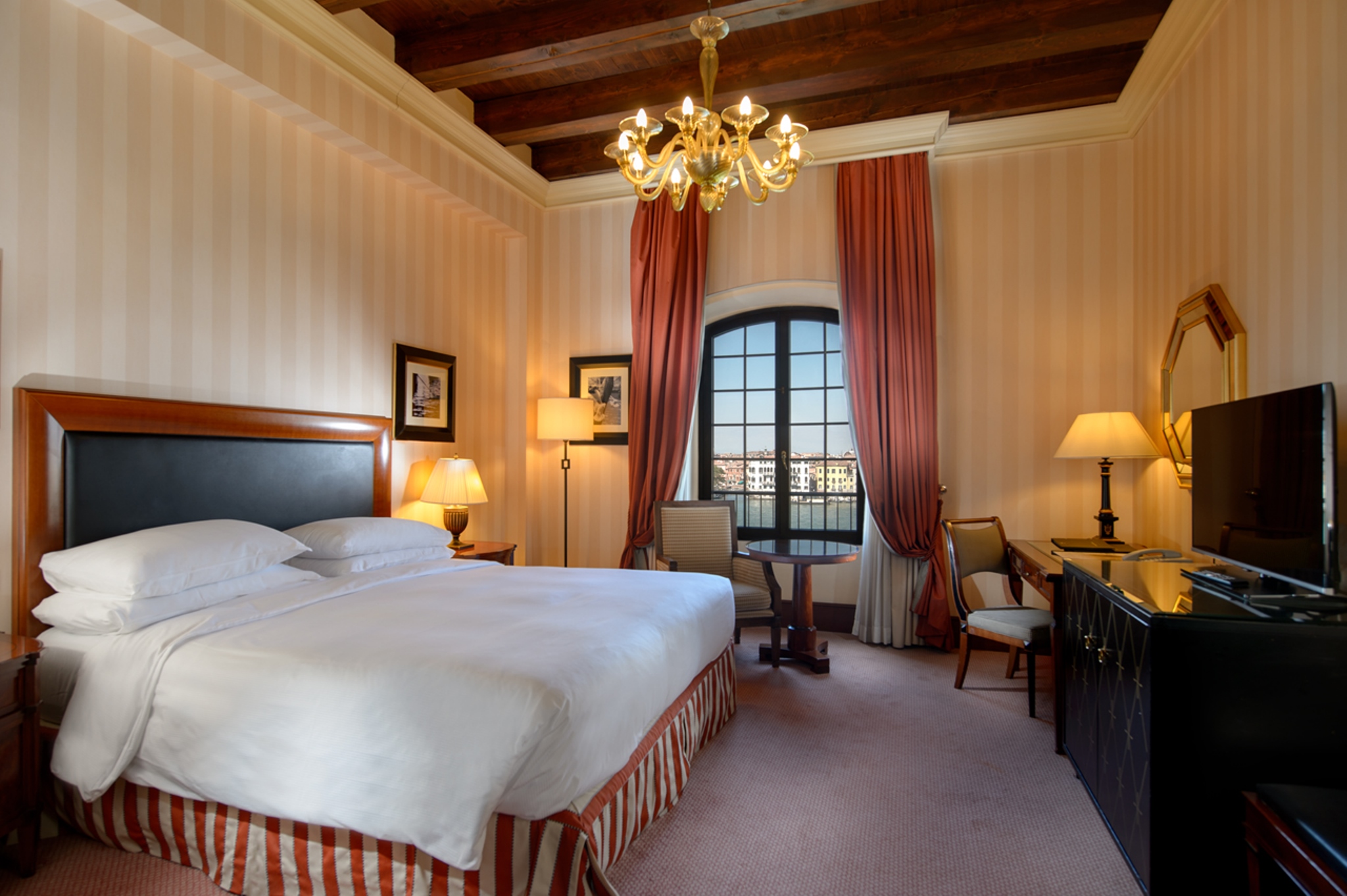 a room with a bed and a desk and chairs