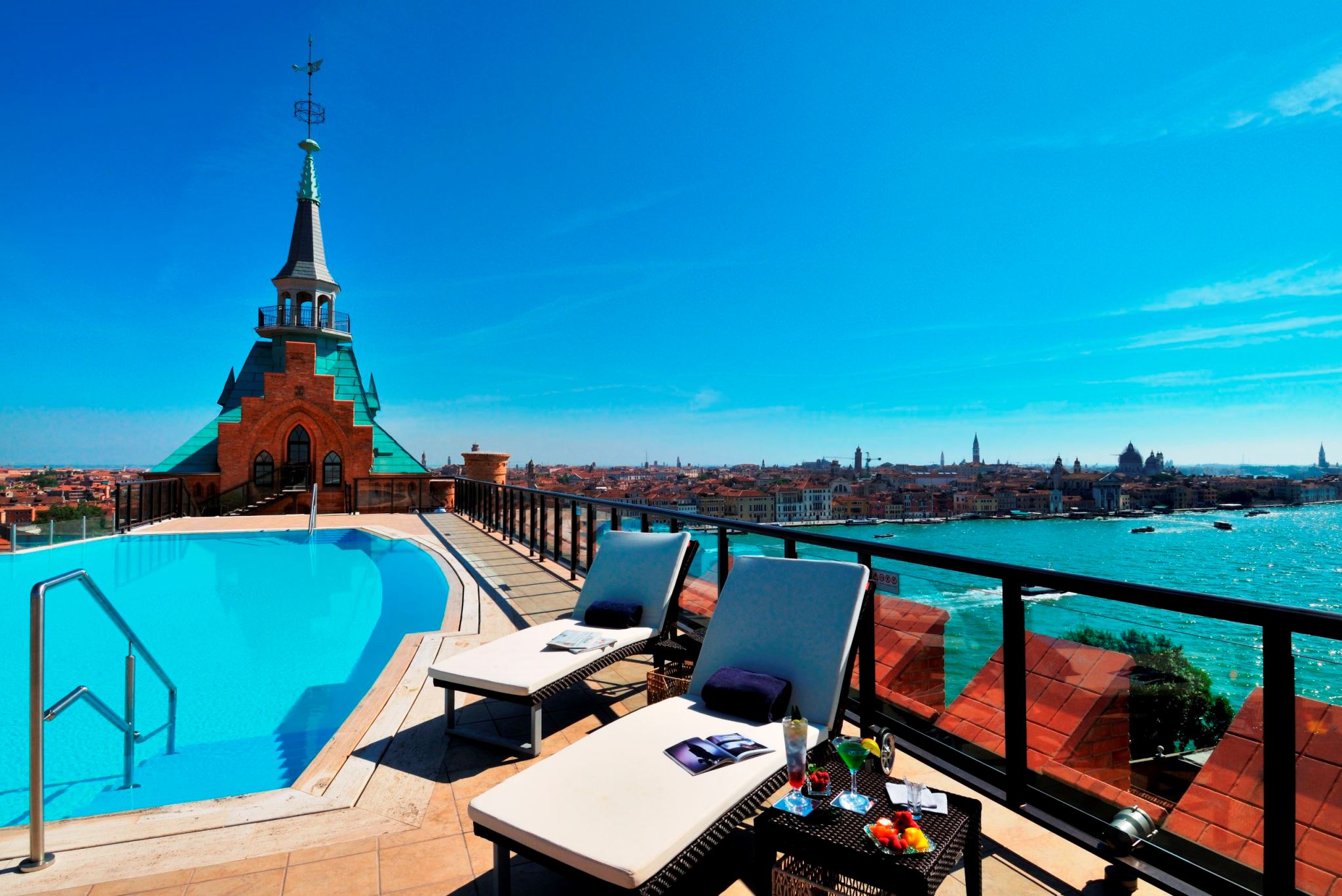 a pool with a rooftop view of a city and a tower