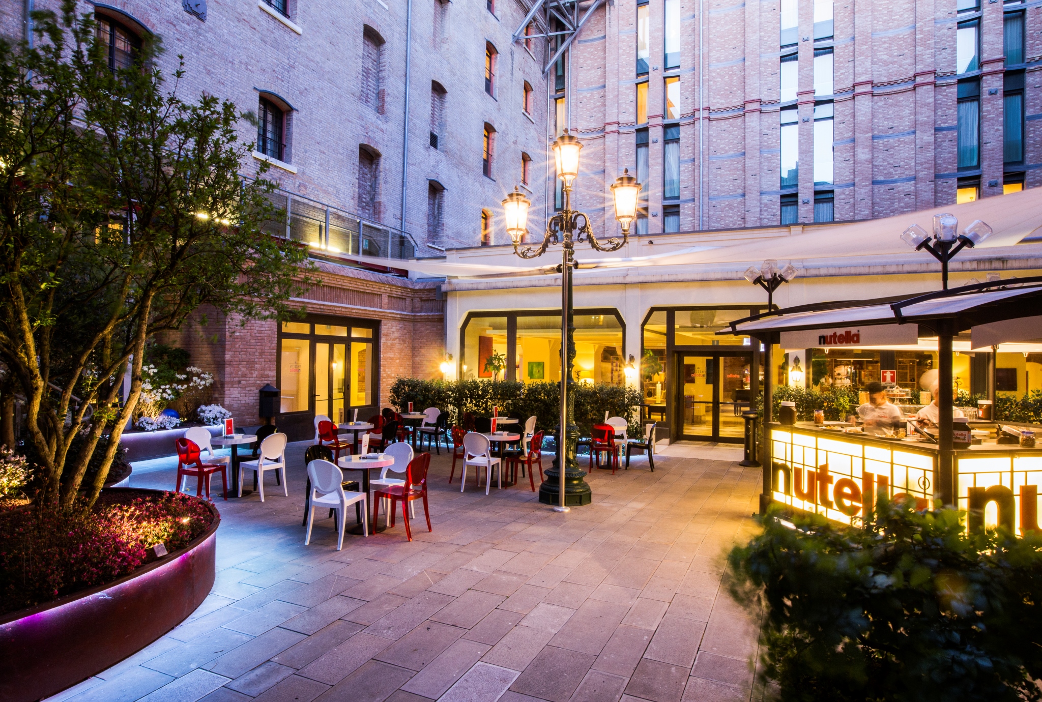 a courtyard with tables and chairs
