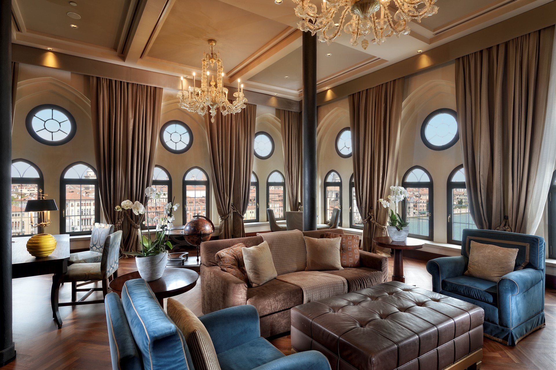 a room with a chandelier and couches