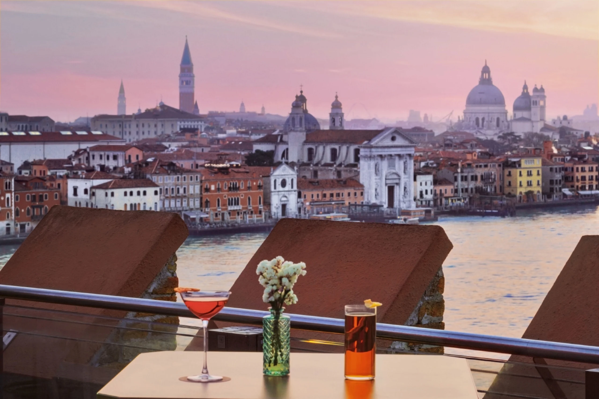 a table with drinks on it and a city in the background
