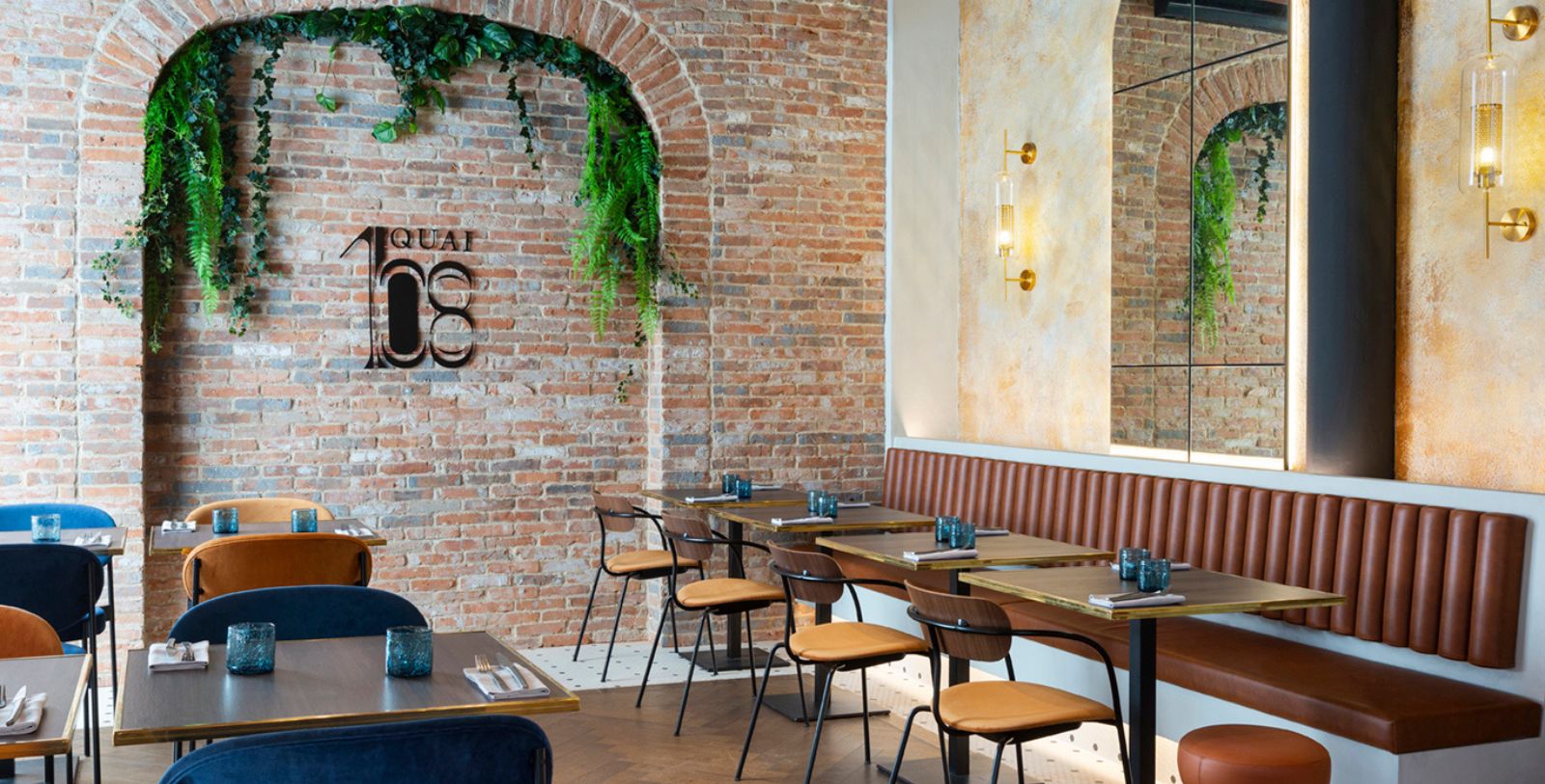 a room with a brick wall and a table and chairs