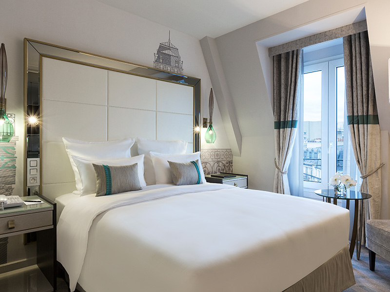 a bed with pillows and a window