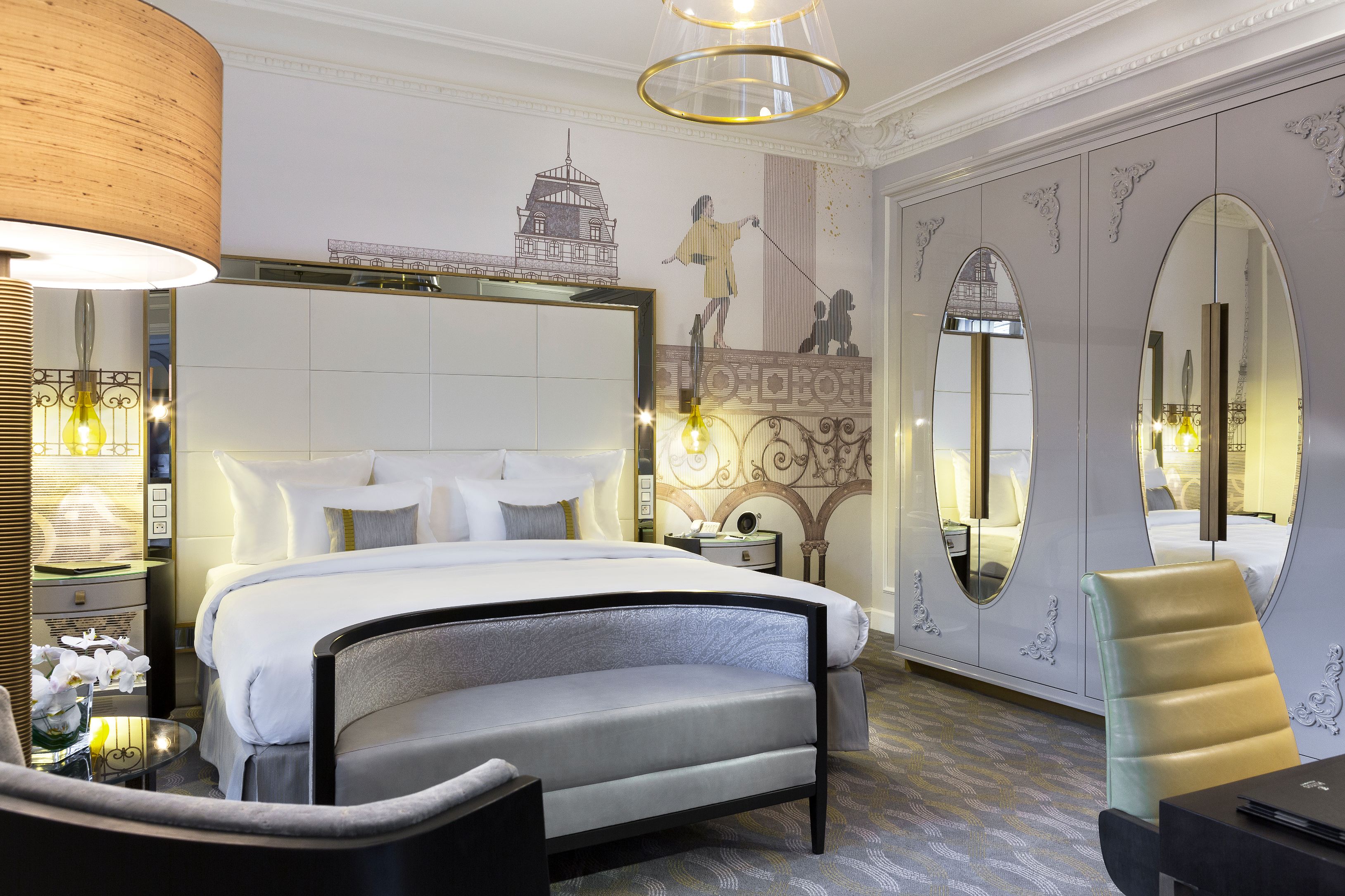 a room with a bed and chairs