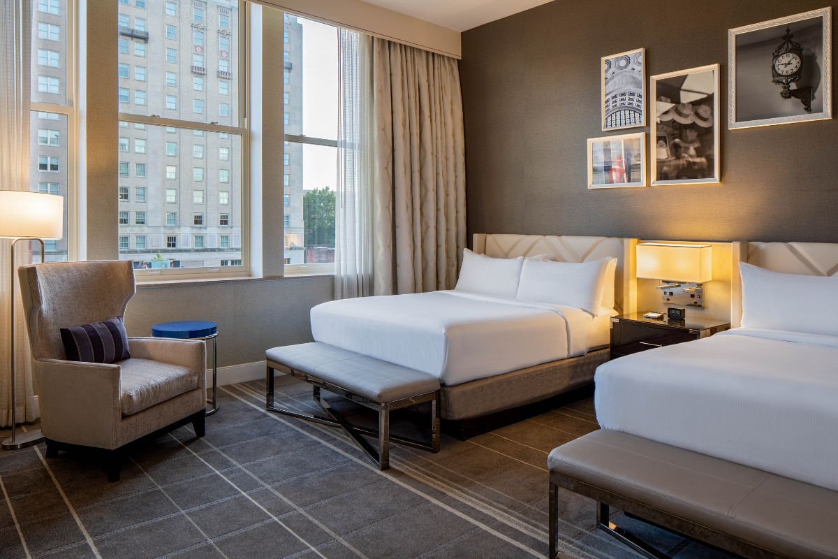a room with two beds and a lamp