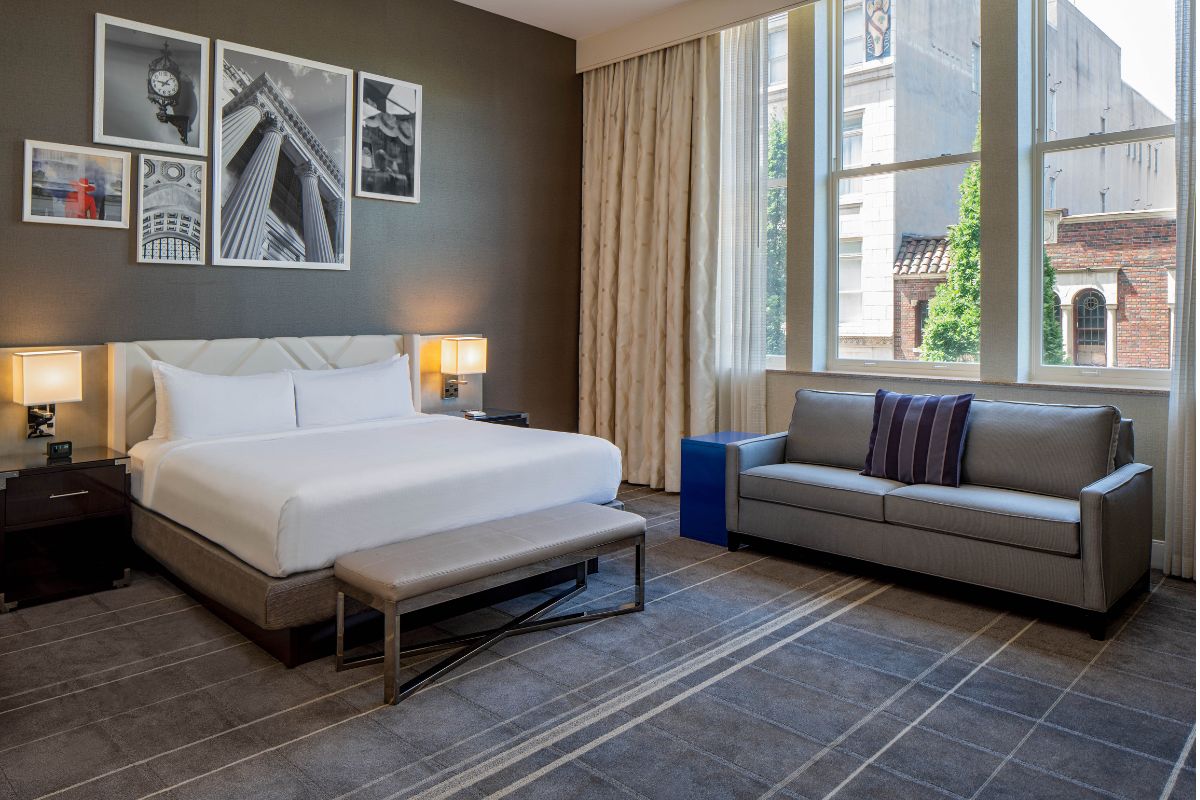 a room with a bed and couches