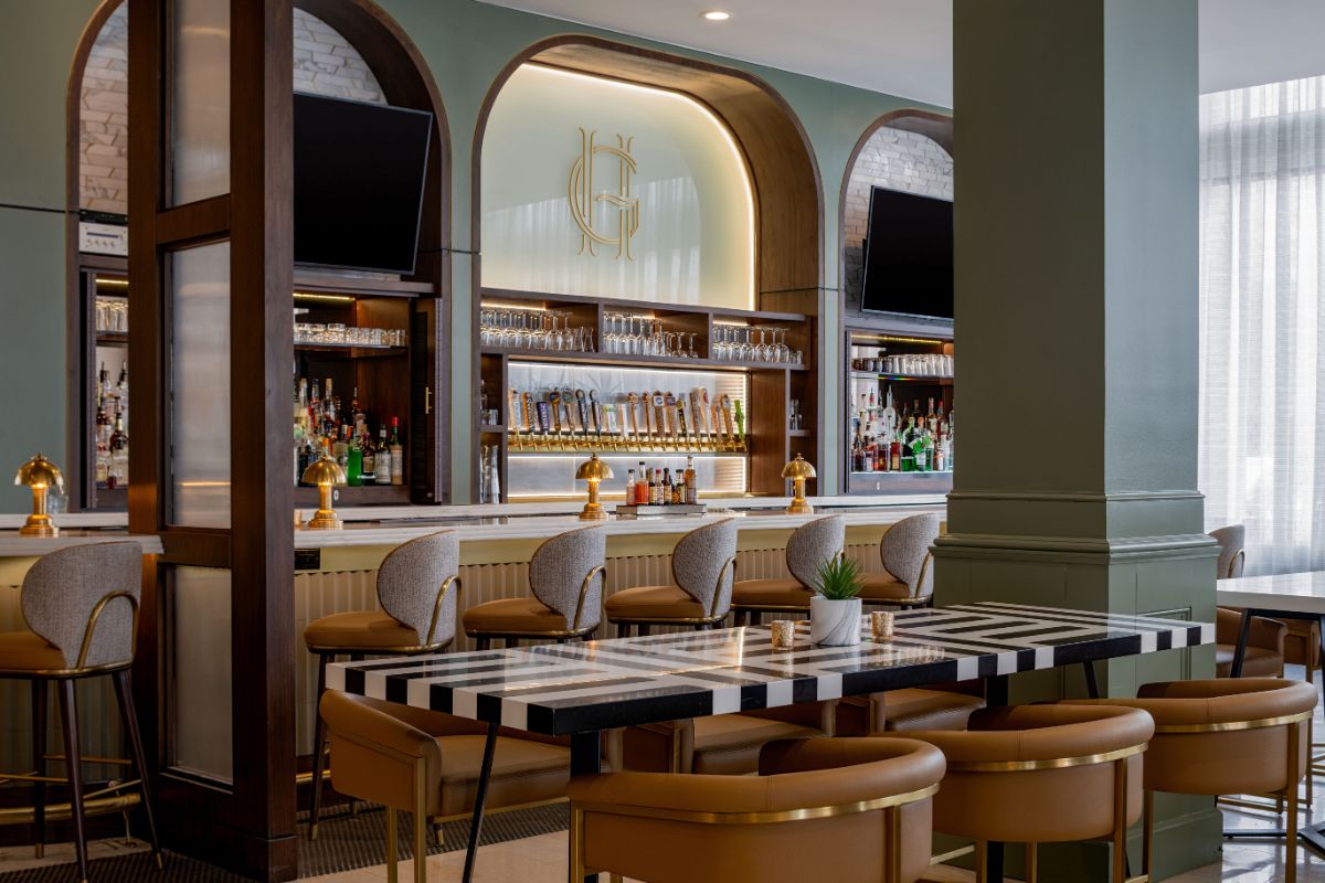 a bar with a black and white striped table and chairs