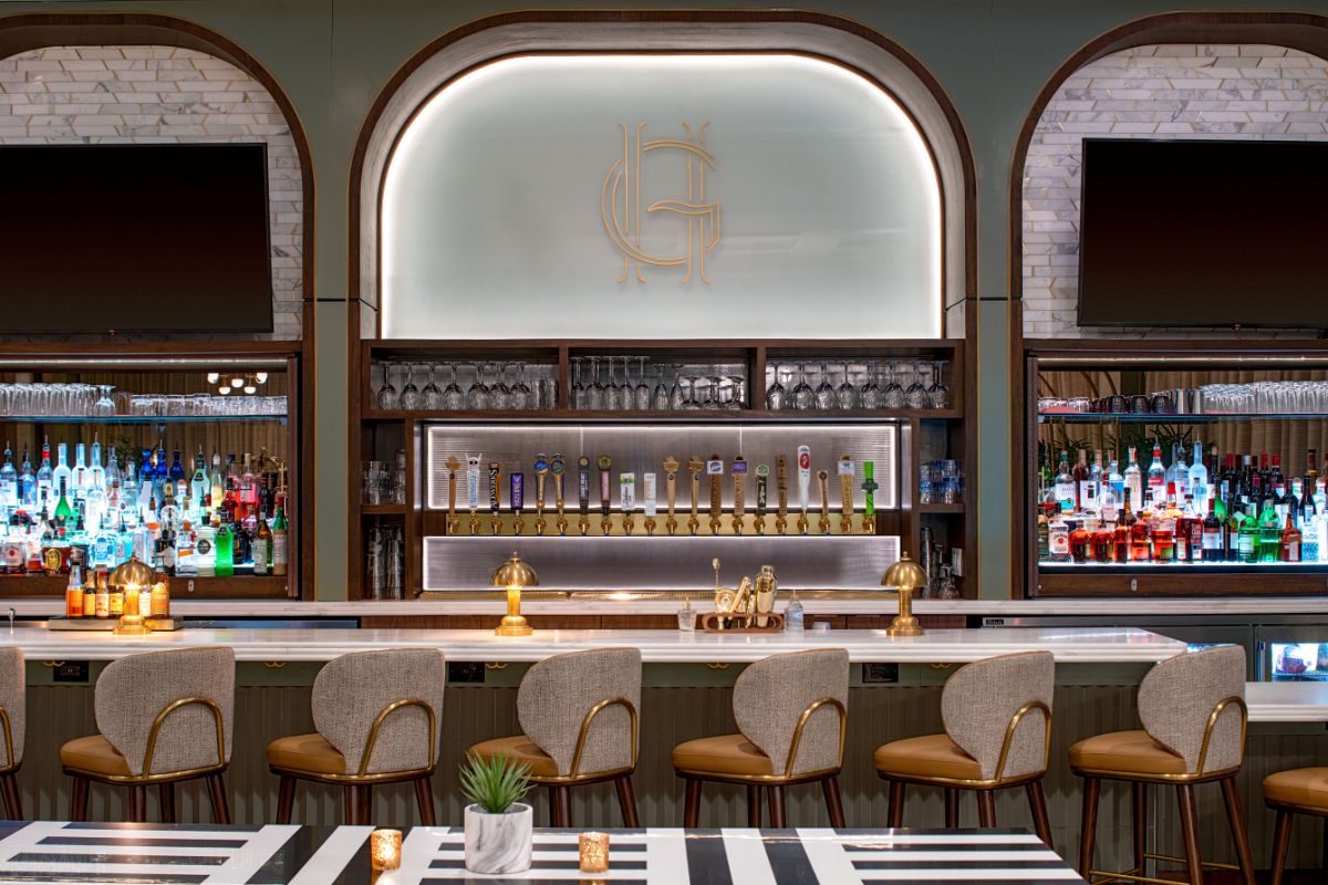 a bar with a row of chairs and a table
