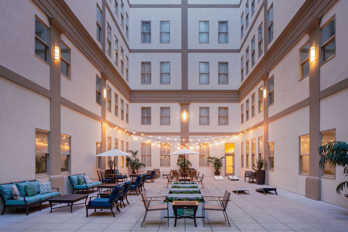 a courtyard with chairs and tables