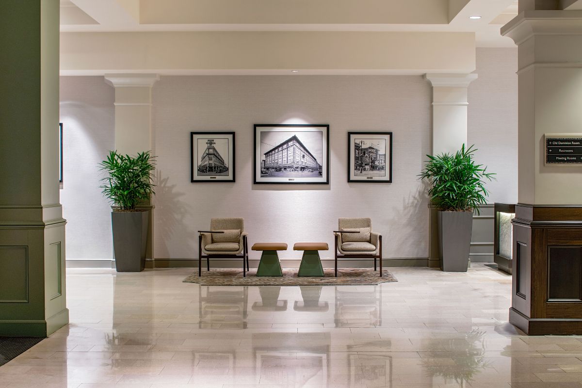a room with white columns and chairs and a table