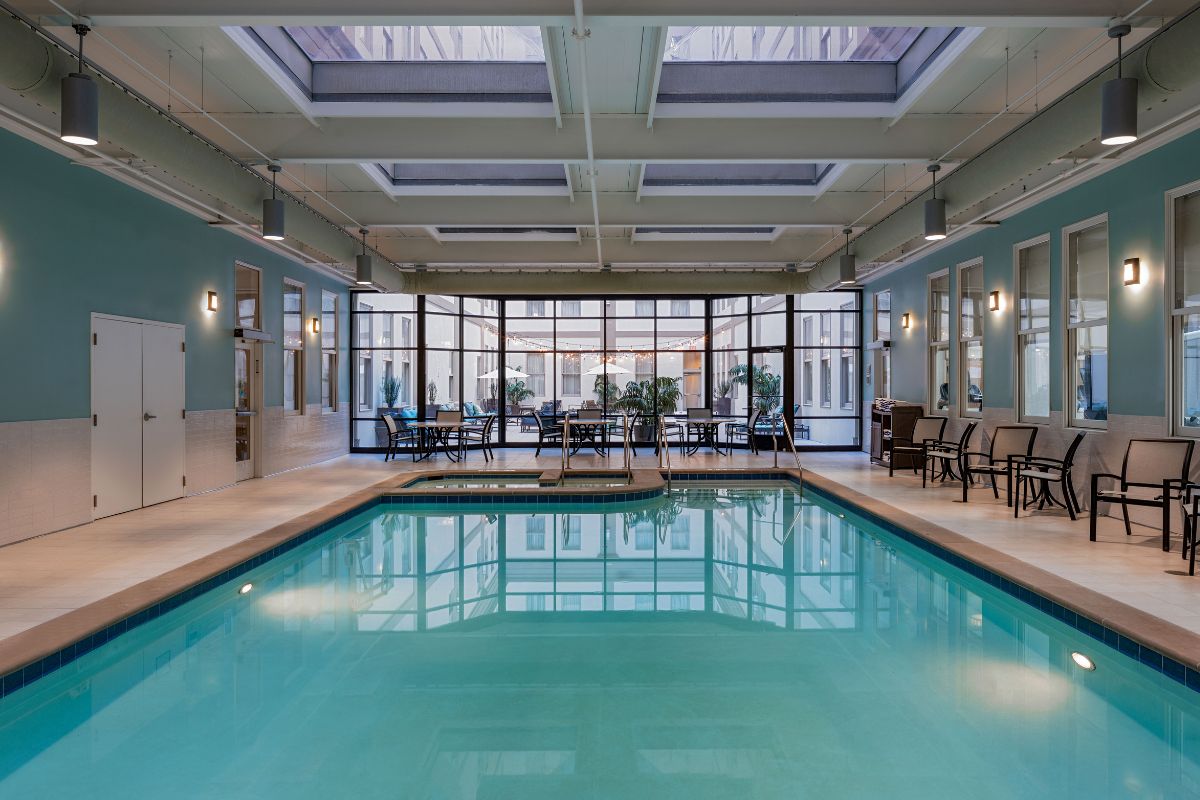 a indoor swimming pool with a large glass wall