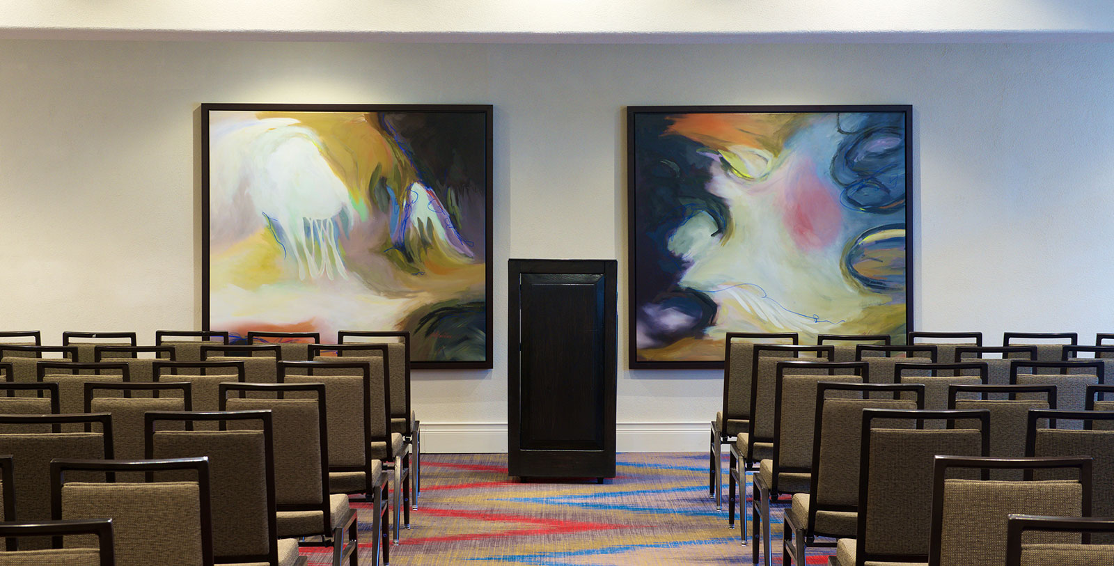 a room with chairs and art on the wall