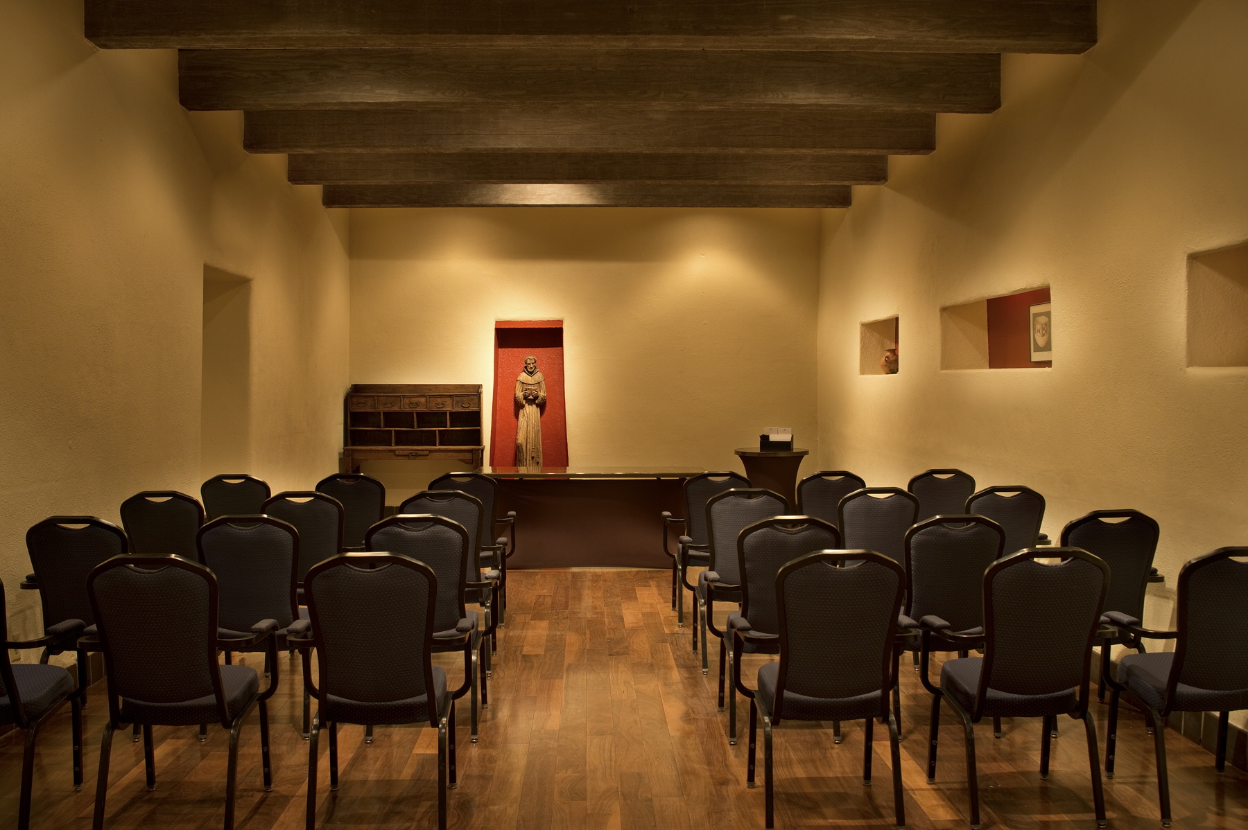 a room with chairs and a statue
