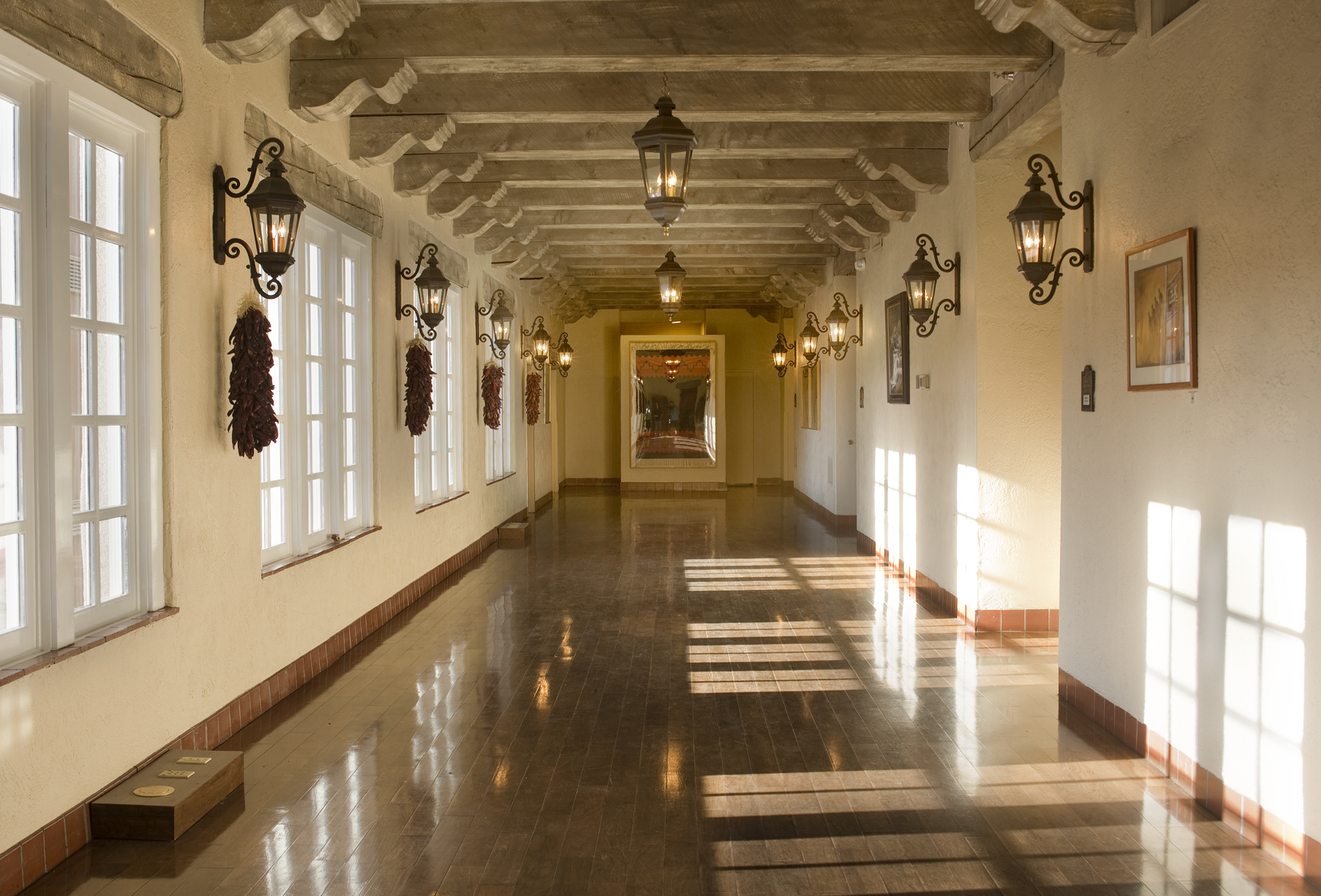 a long hallway with lights and a mirror