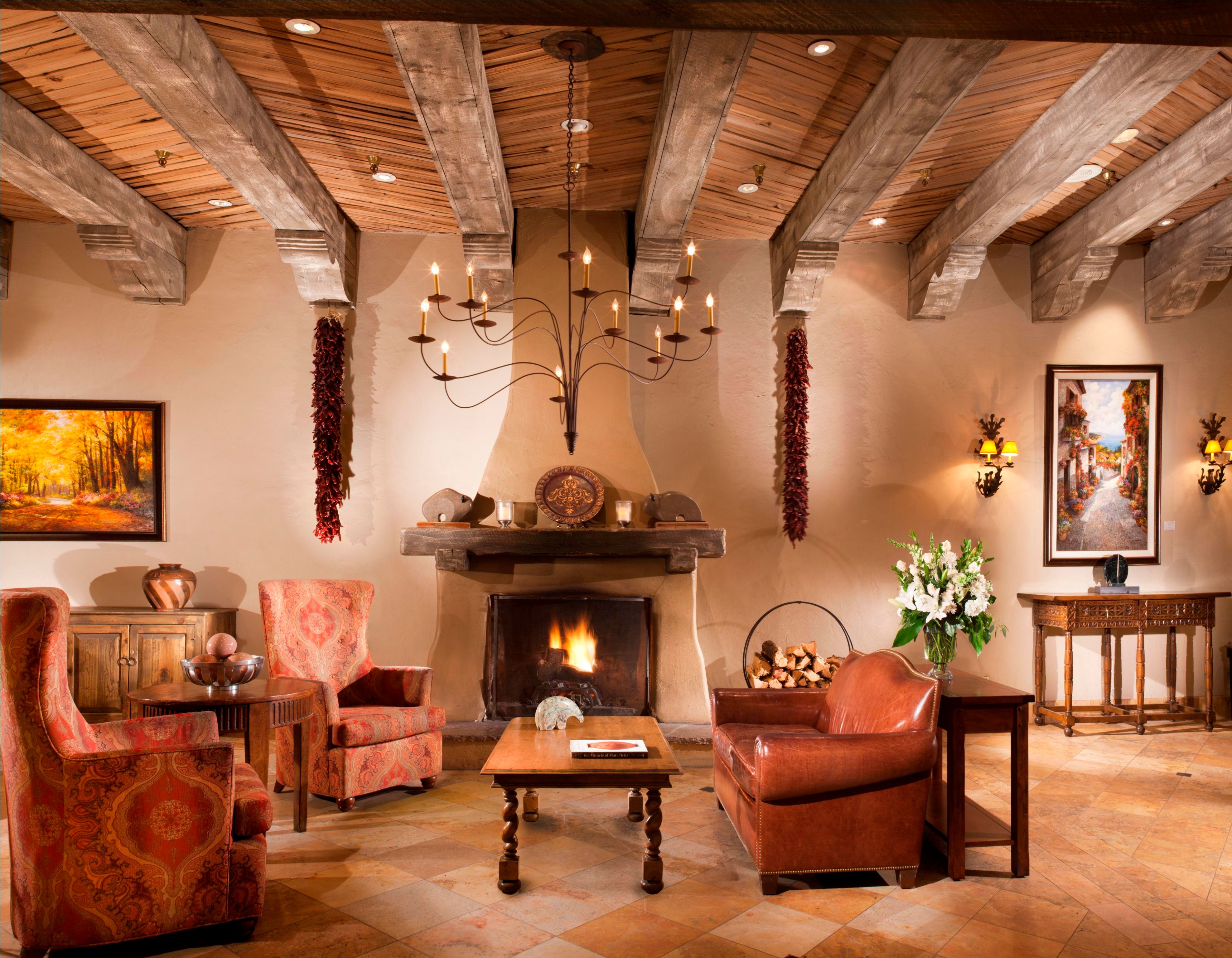 a room with a fireplace and chairs
