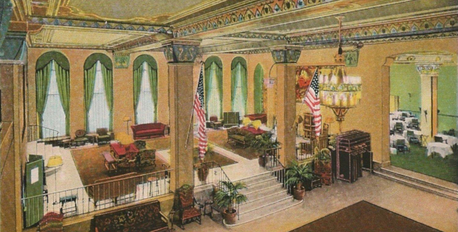 a room with a staircase and flags
