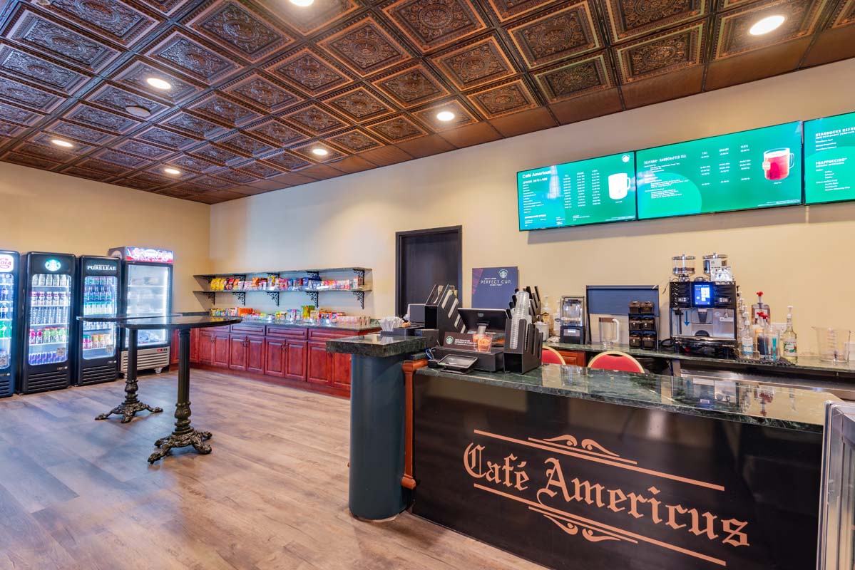 a coffee shop with a counter and a tv
