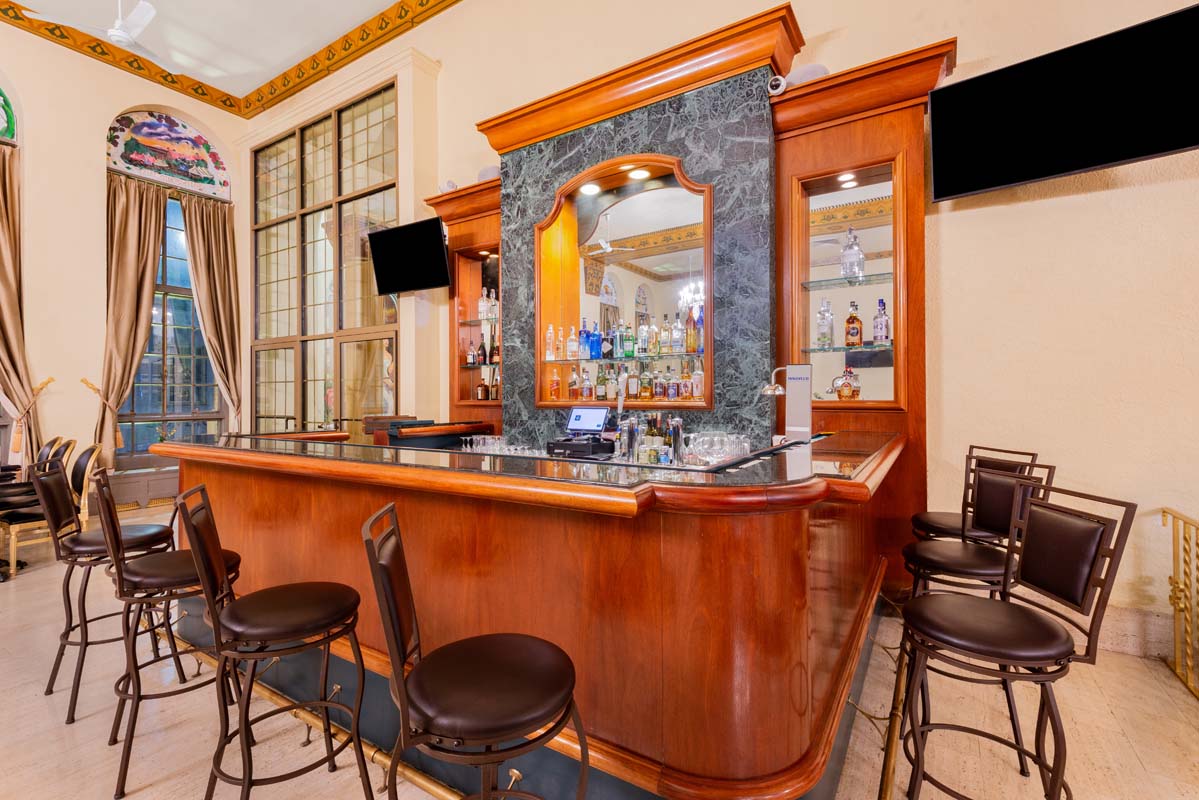 a bar with a counter and chairs