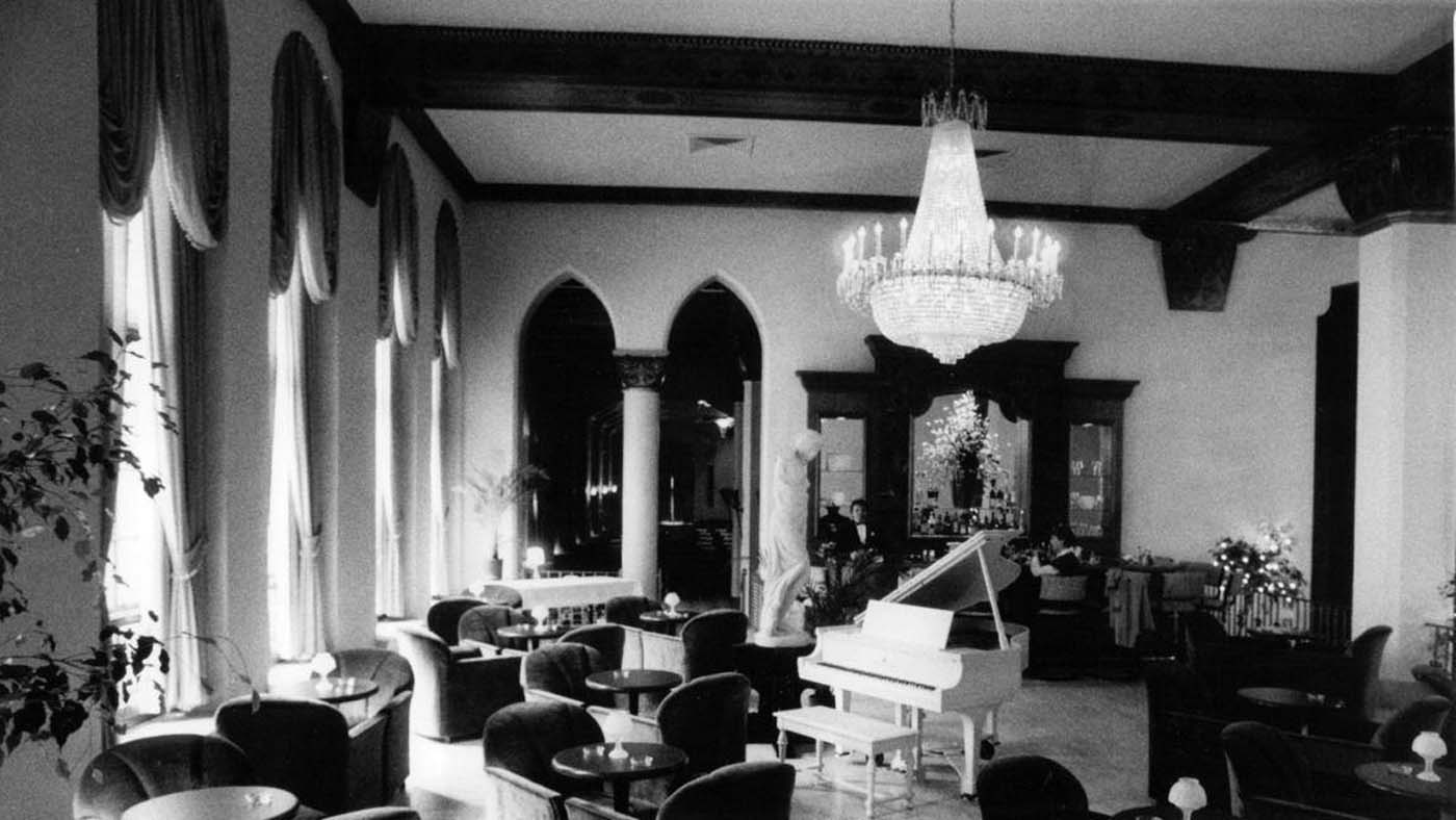 a room with a piano and chairs